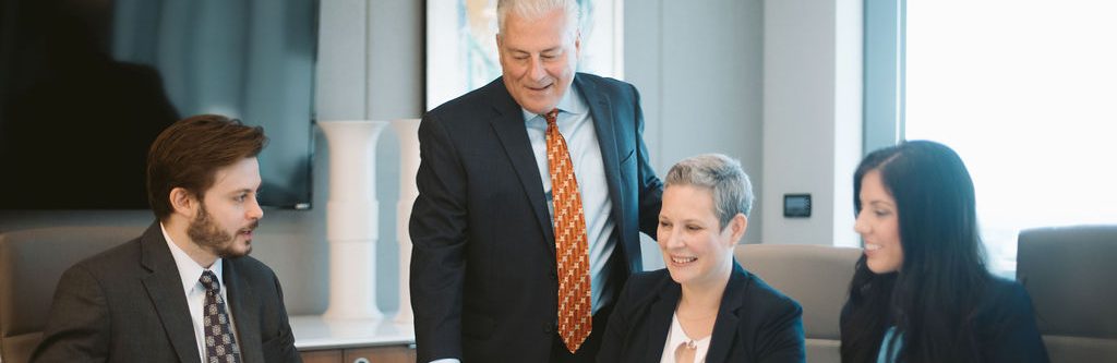 Men and women in business attire having a business meeting.